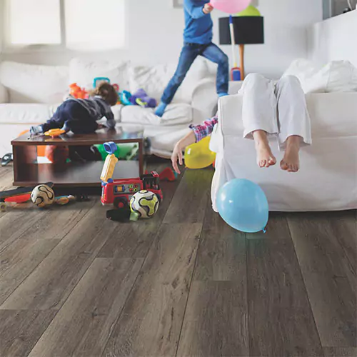 types-of-luxury-vinyl kids playing in living room | Yetzer Home Store