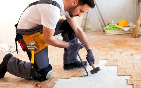 Worker removing old flooring | Yetzer Home Store