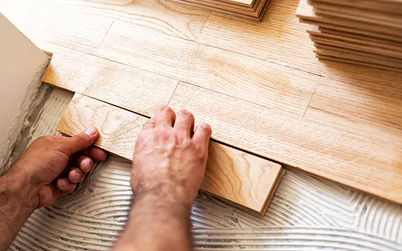 Worker installing hardwood | Yetzer Home Store