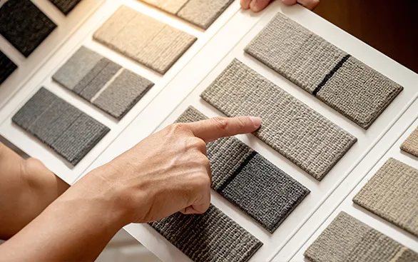 Person selecting a carpet sample | Yetzer Home Store