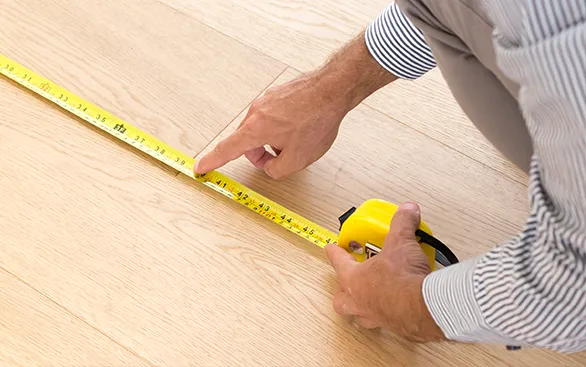 Worker measuring a room | Yetzer Home Store